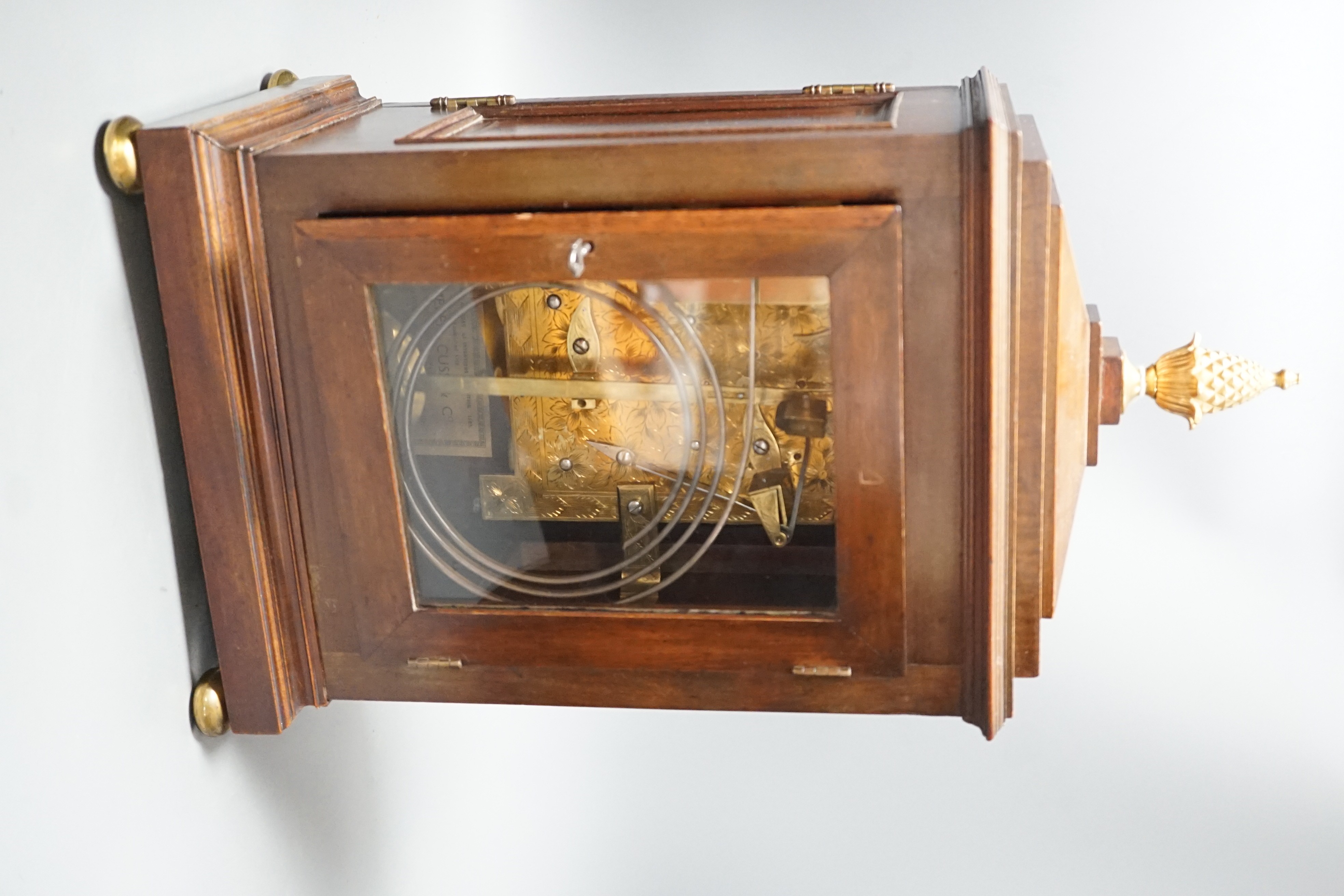 A Regency brass inlaid mahogany bracket clock, with pineapple finial, bears interior paper label Cuss & Co. 49cm high